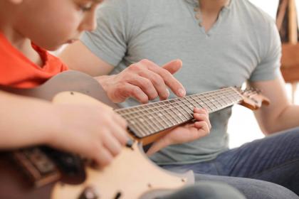 Child in guitar lesson in Richmond VA